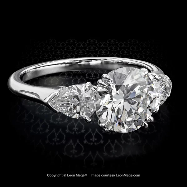 Leon Megé classic three-stone engagement ring precision-forged in platinum with a round diamond and pear-shape diamonds on the sides r5454