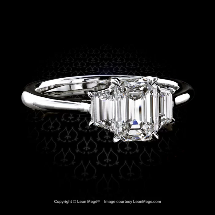 Leon Megé classic three-stone ring with an emerald cut diamond and a pair of step-cut trapezoids