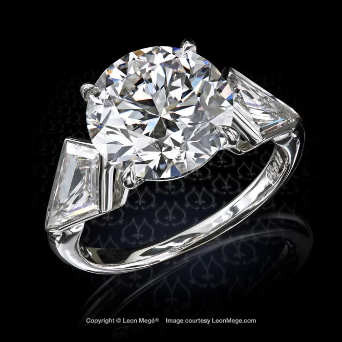 Leon Megé three-stone engagement ring with a round diamond and a pair of kites r7821