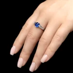 Leon Megé platinum right-hand ring with a natural sugarloaf cabochon Kashmir sapphire and channel-set French cut diamonds.