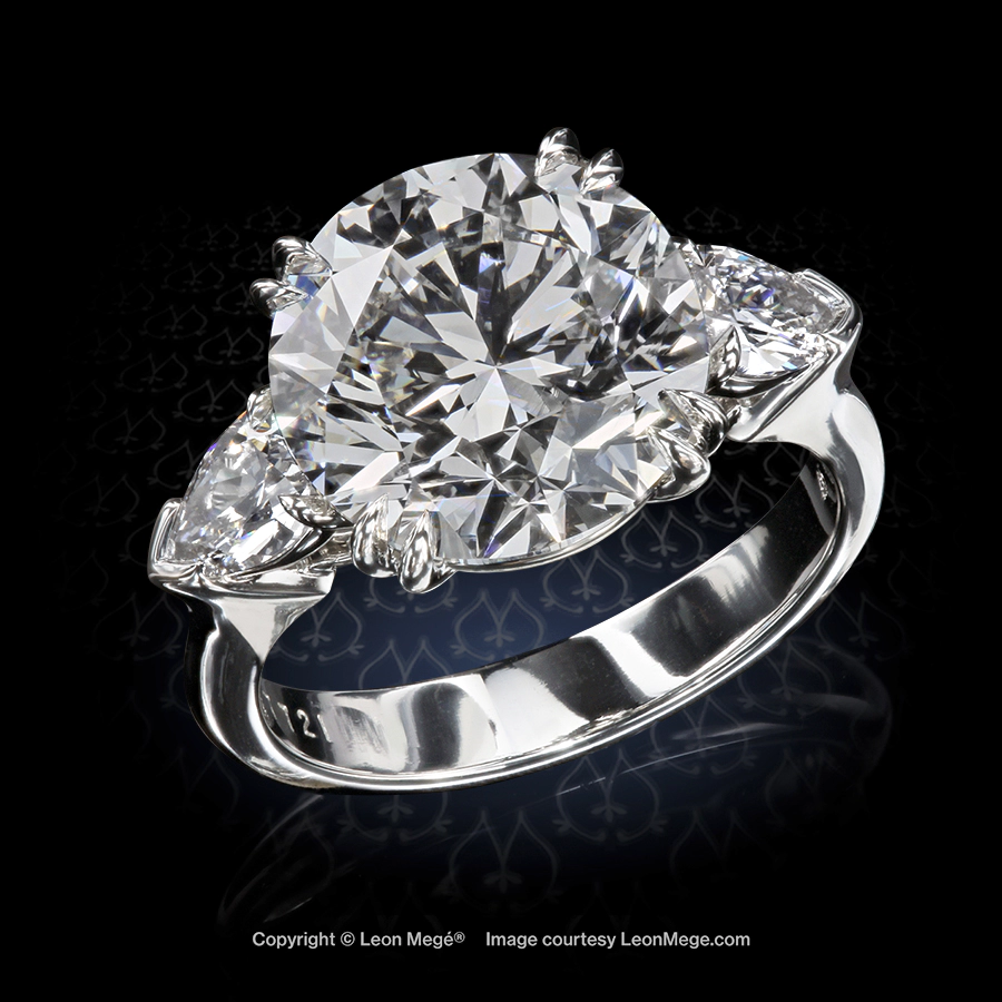 Leon Megé bespoke engagement three-stone ring with a round diamond and pear-shape sides r7721